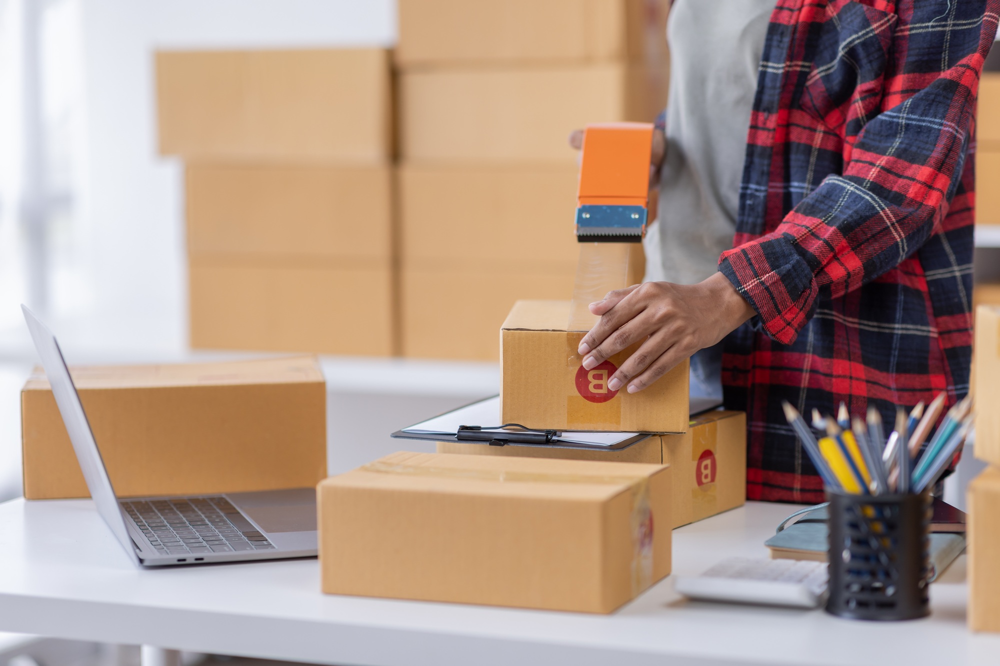 Portrait of Young African American business woman SME e-commerce employee sitting at home full of pa